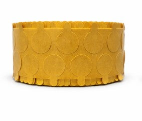 Yellow circular adhesive disc tabs on a yellow roll