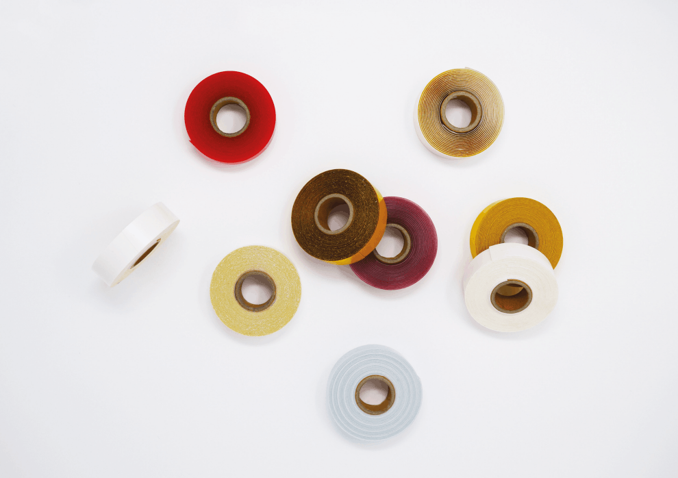 Assorted spools of tape on a white background